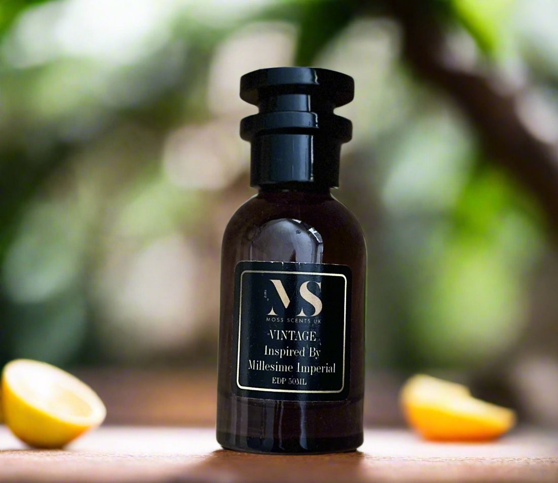50 ML bottle of millesime imperial Inspired perfume - Vintange, surrounded with orange and lemon