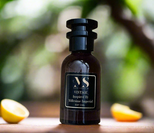 50 ML bottle of millesime imperial Inspired perfume - Vintange, surrounded with orange and lemon 